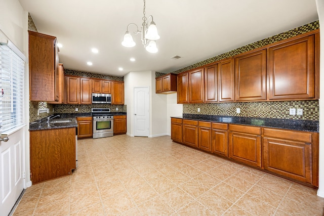 506 Stream Mill Ln, Katy, TX 77494 - kitchen with stainless steel appliances, brown cabinetry, a chandelier, tasteful backsplash, and a sink