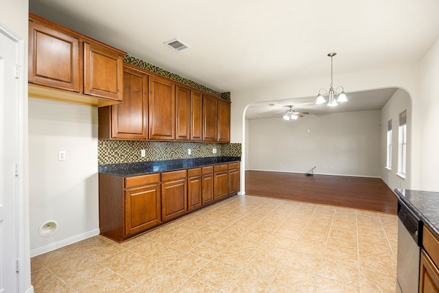 506 Stream Mill Ln, Katy, TX 77494 - kitchen with arched walkways, brown cabinets, a ceiling fan, and tasteful backsplash