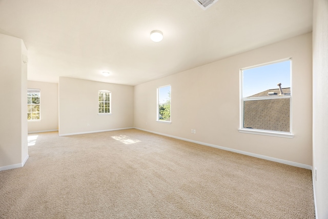 506 Stream Mill Ln, Katy, TX 77494 - empty room with plenty of natural light, baseboards, and light colored carpet