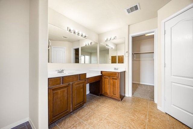 506 Stream Mill Ln, Katy, TX 77494 - full bathroom featuring double vanity, a walk in closet, baseboards, and tile patterned flooring