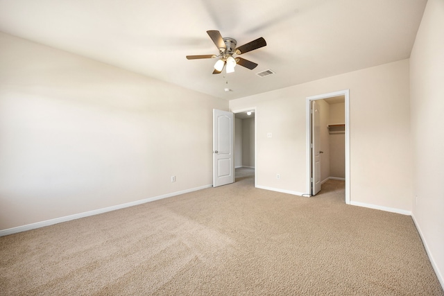 506 Stream Mill Ln, Katy, TX 77494 - unfurnished bedroom with baseboards, light carpet, a walk in closet, a ceiling fan, and a closet