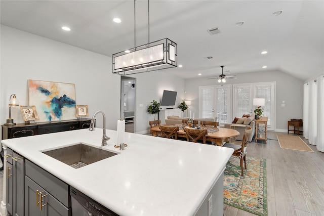 kitchen with a sink, light wood-style flooring, recessed lighting, light countertops, and ceiling fan