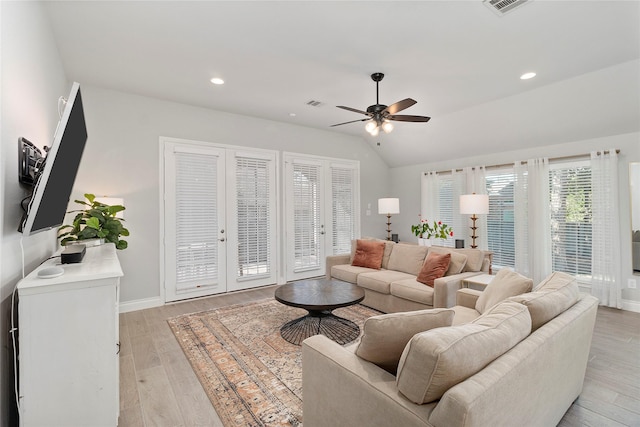 living room featuring a ceiling fan, baseboards, lofted ceiling, light wood-type flooring, and recessed lighting