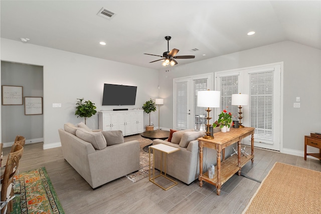 living area featuring light wood finished floors, baseboards, ceiling fan, recessed lighting, and lofted ceiling