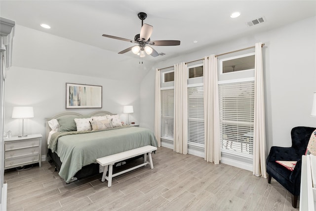 bedroom featuring light wood finished floors, vaulted ceiling, recessed lighting, baseboards, and a ceiling fan