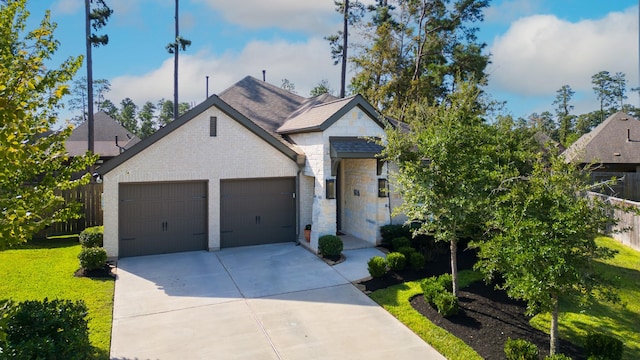 french country inspired facade with stone siding, a garage, concrete driveway, and fence