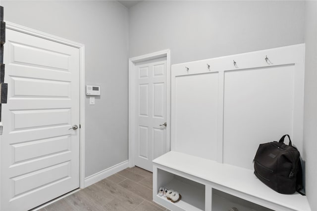 mudroom with light wood-style floors and baseboards