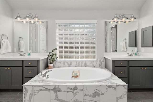 full bathroom featuring a bath and two vanities
