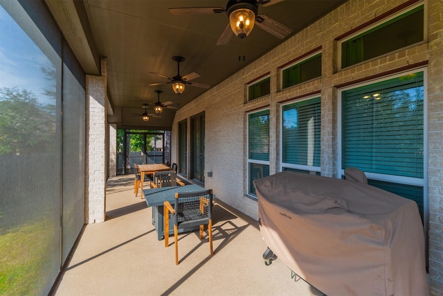 view of patio / terrace with a ceiling fan, fence, and a grill