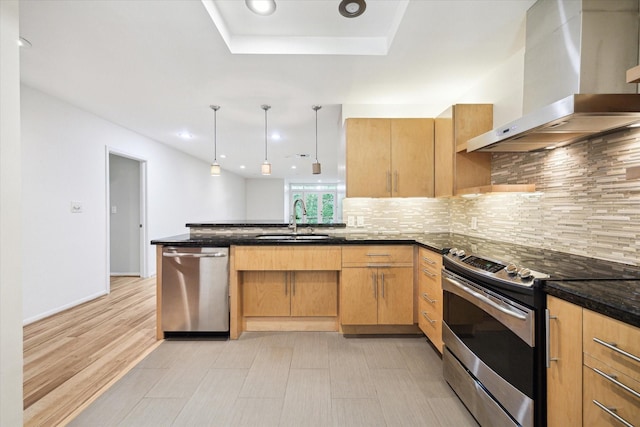 6549 Bayou Glen Rd, Houston, TX 77057 - kitchen with wall chimney range hood, appliances with stainless steel finishes, a sink, a peninsula, and tasteful backsplash