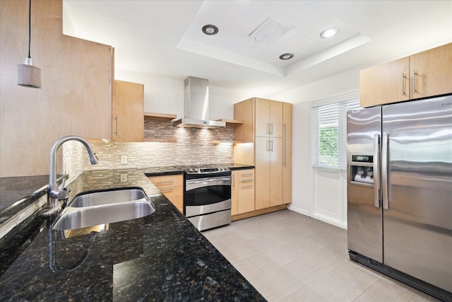 6549 Bayou Glen Rd, Houston, TX 77057 - kitchen featuring stainless steel appliances, wall chimney range hood, a sink, light brown cabinetry, and tasteful backsplash