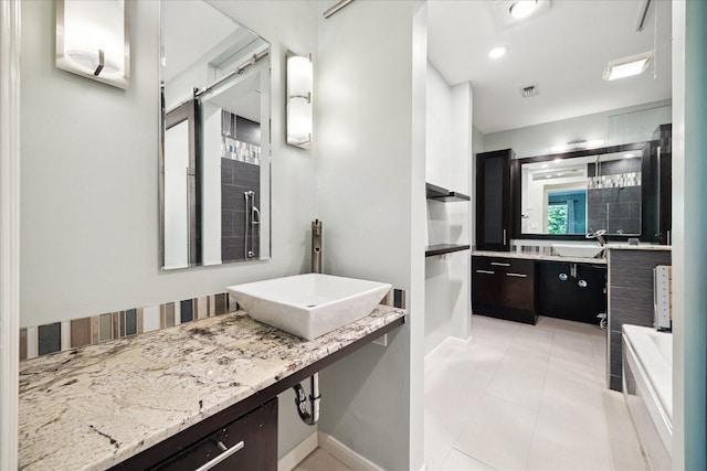 6549 Bayou Glen Rd, Houston, TX 77057 - bathroom with a bathtub, baseboards, tile patterned flooring, and vanity