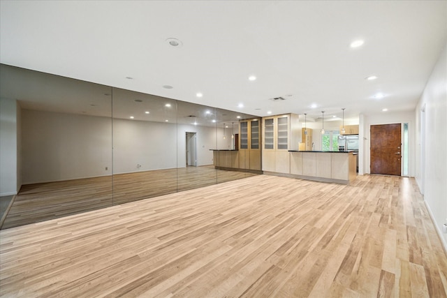 6549 Bayou Glen Rd, Houston, TX 77057 - unfurnished living room with light wood-style flooring and recessed lighting