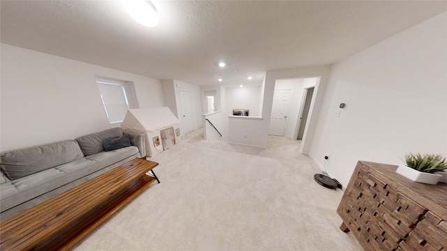living area featuring an upstairs landing, light carpet, and recessed lighting
