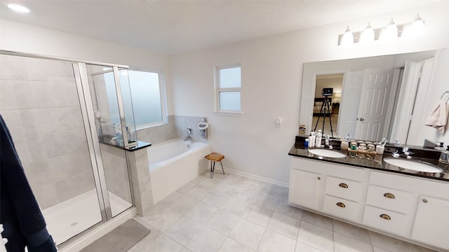 full bath with a shower stall, a garden tub, double vanity, tile patterned floors, and baseboards