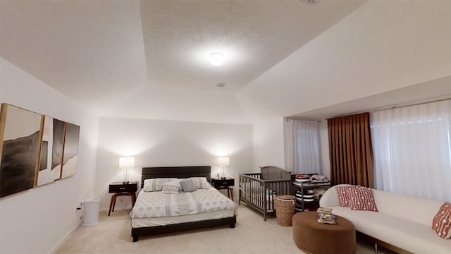 bedroom with carpet flooring, baseboards, and a textured ceiling