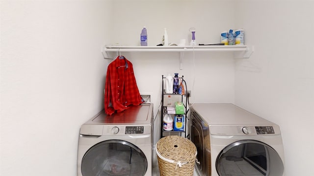 clothes washing area with separate washer and dryer