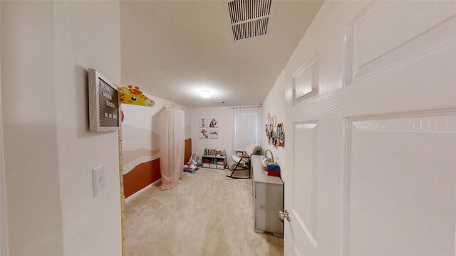 hallway with light carpet
