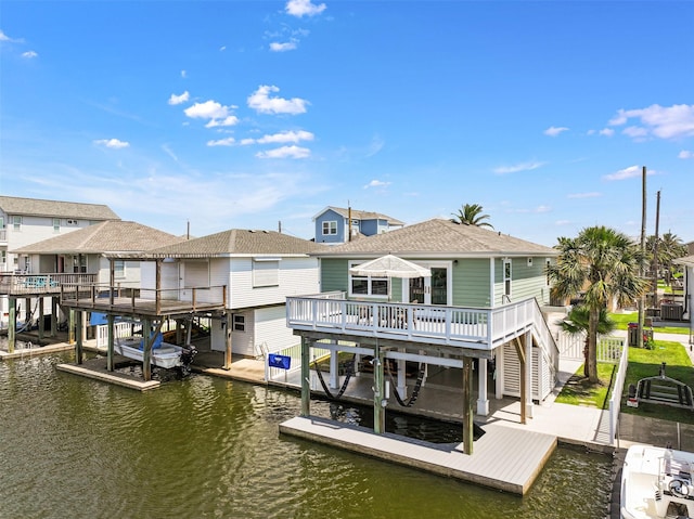 16716 Tahiti Way, Galveston, TX 77554 - rear view of property featuring boat lift, a residential view, roof with shingles, and stairs