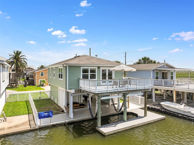 16716 Tahiti Way, Galveston, TX 77554 - back of property with fence, a deck with water view, and a shingled roof