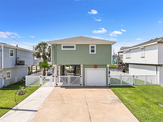 16716 Tahiti Way, Galveston, TX 77554 - coastal inspired home featuring a gate, a garage, concrete driveway, and central AC