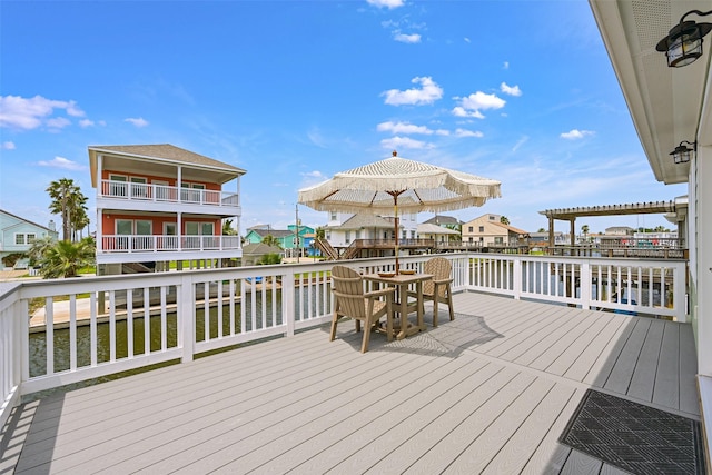 16716 Tahiti Way, Galveston, TX 77554 - wooden terrace featuring a water view and outdoor dining space