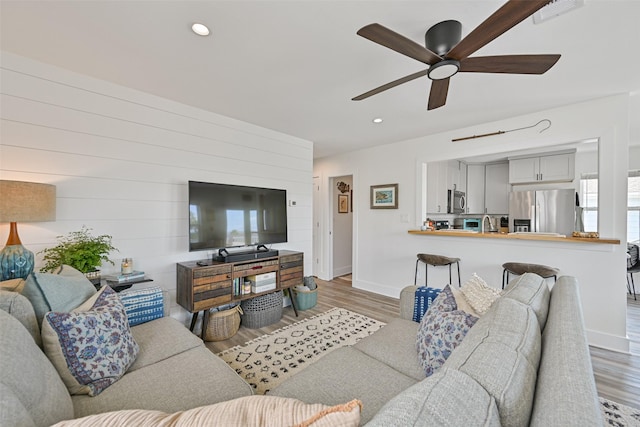 16716 Tahiti Way, Galveston, TX 77554 - living room with wood finished floors, a ceiling fan, recessed lighting, and baseboards