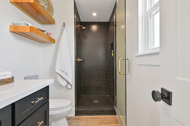 16716 Tahiti Way, Galveston, TX 77554 - full bathroom with a shower stall, toilet, wood finished floors, vanity, and recessed lighting