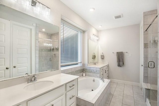 13814 Russell Ct, Mont Belvieu, TX 77523 - bathroom with a shower stall, a garden tub, two vanities, and baseboards