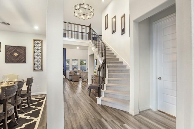 13814 Russell Ct, Mont Belvieu, TX 77523 - entrance foyer featuring wood finished floors, baseboards, a chandelier, stairway, and recessed lighting