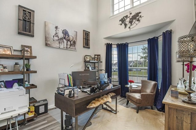 13814 Russell Ct, Mont Belvieu, TX 77523 - office with wood finished floors, a towering ceiling, and baseboards