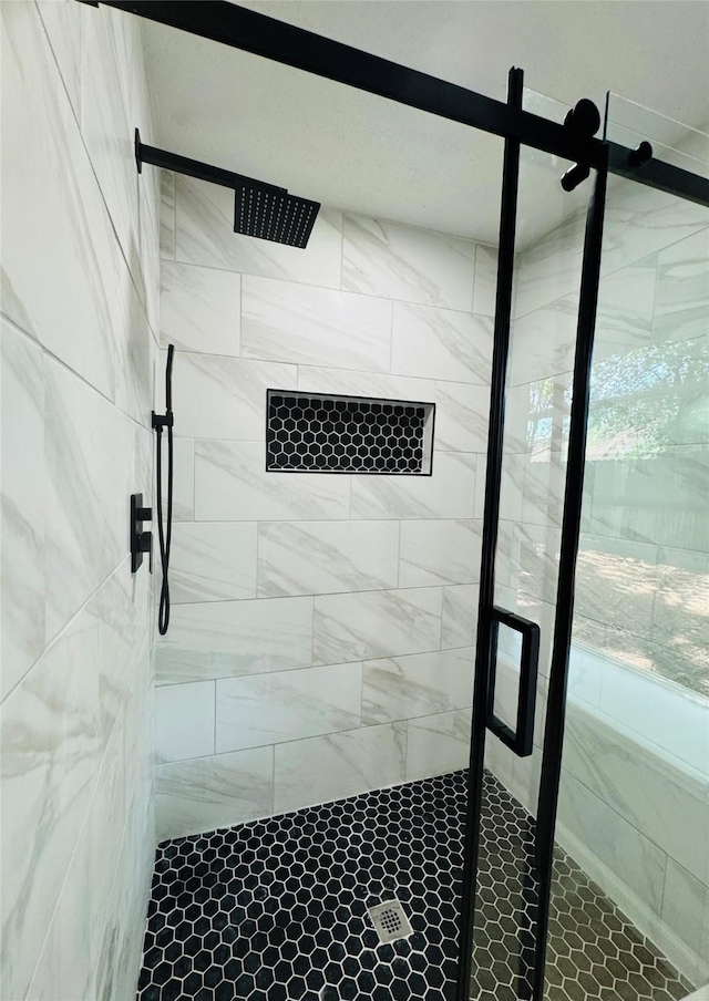 full bath with a shower stall and healthy amount of natural light