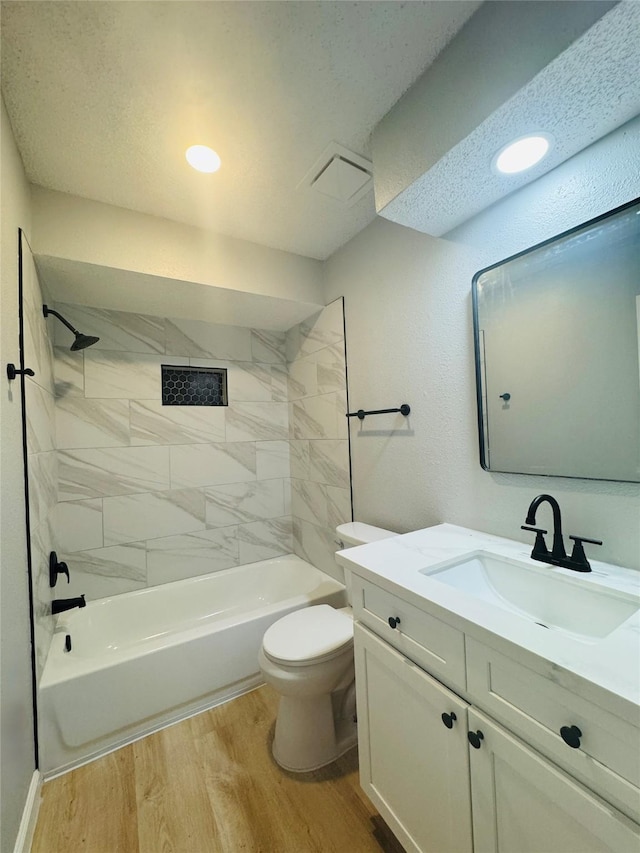 full bathroom with wood finished floors, toilet, vanity, and shower / washtub combination