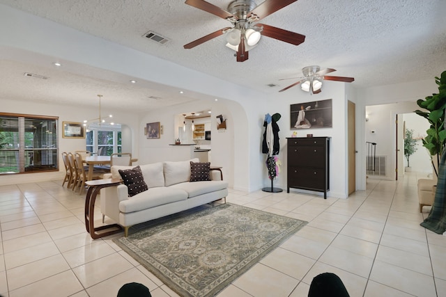 105 N Delmont Dr E, Conroe, TX 77301 - living area featuring a textured ceiling, ceiling fan, light tile patterned flooring, arched walkways, and recessed lighting