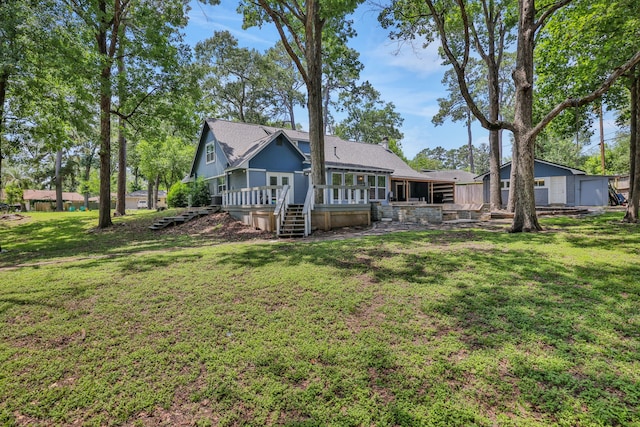 105 N Delmont Dr E, Conroe, TX 77301 - back of property featuring a yard, a wooden deck, and stairs