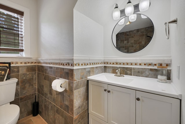 105 N Delmont Dr E, Conroe, TX 77301 - bathroom featuring tile walls, toilet, a wainscoted wall, and vanity