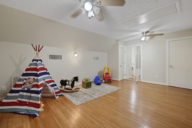 105 N Delmont Dr E, Conroe, TX 77301 - recreation room featuring a ceiling fan, a textured ceiling, attic access, hardwood / wood-style floors, and baseboards