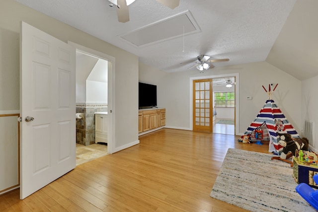 105 N Delmont Dr E, Conroe, TX 77301 - game room featuring attic access, a ceiling fan, light wood-type flooring, and a textured ceiling