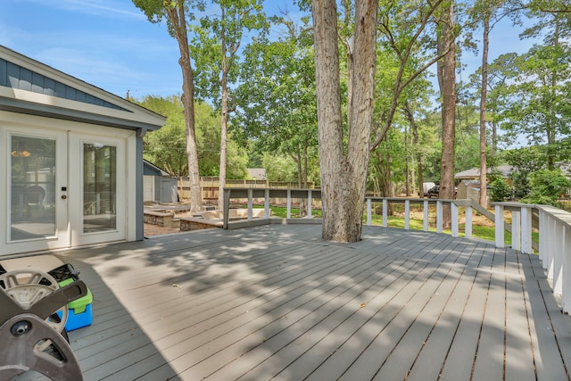 105 N Delmont Dr E, Conroe, TX 77301 - wooden terrace featuring french doors, a fenced backyard, and view of wooded area