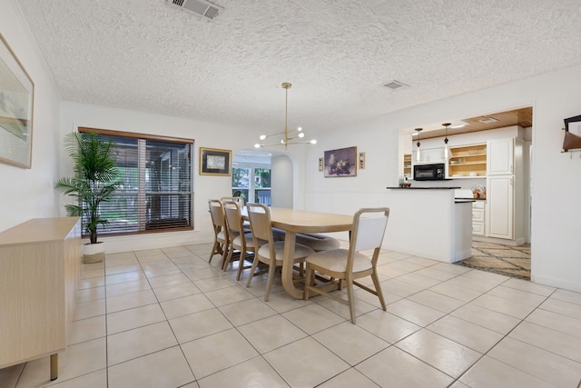105 N Delmont Dr E, Conroe, TX 77301 - dining space with light tile patterned flooring and a textured ceiling