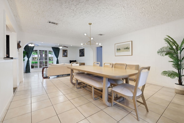 105 N Delmont Dr E, Conroe, TX 77301 - dining area with a ceiling fan, light tile patterned floors, arched walkways, and a textured ceiling
