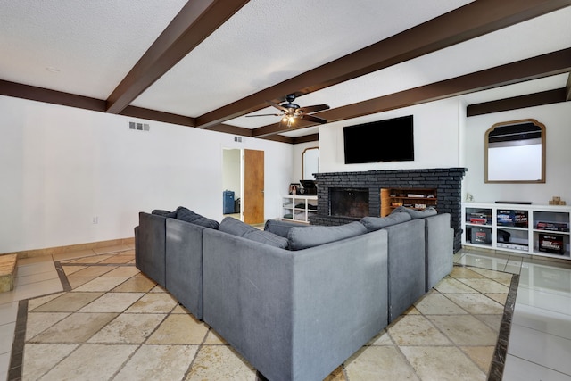 105 N Delmont Dr E, Conroe, TX 77301 - living room featuring beamed ceiling, stone tile floors, a fireplace, baseboards, and ceiling fan
