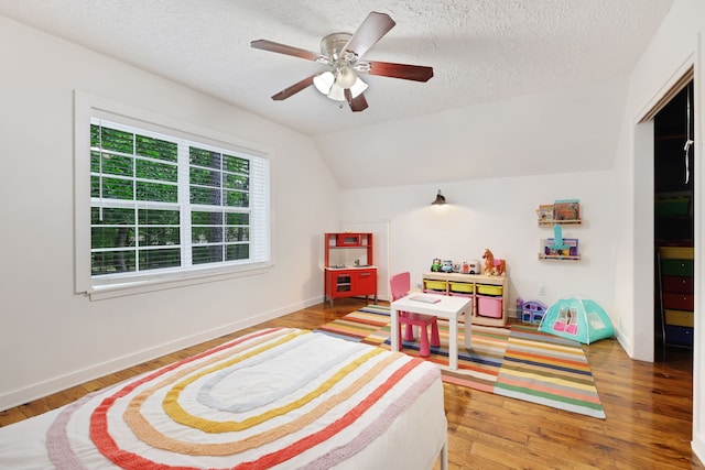 105 N Delmont Dr E, Conroe, TX 77301 - game room with light wood finished floors, a textured ceiling, ceiling fan, lofted ceiling, and baseboards
