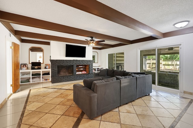 105 N Delmont Dr E, Conroe, TX 77301 - living room featuring ceiling fan, beamed ceiling, a brick fireplace, a textured ceiling, and baseboards