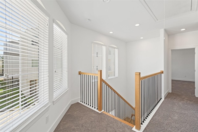 hallway featuring carpet, attic access, healthy amount of natural light, an upstairs landing, and recessed lighting