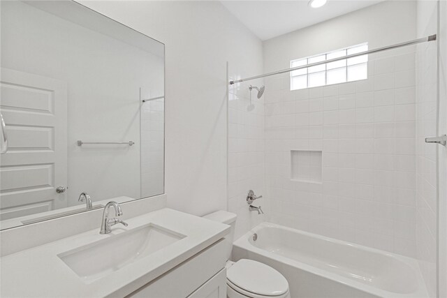 bathroom featuring toilet, tub / shower combination, vanity, and recessed lighting