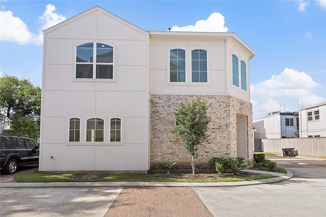 view of front of property featuring fence and stucco siding