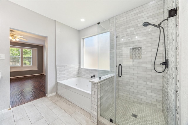 15127 Woodford Hollow Ln, Cypress, TX 77429 - full bath with a shower stall, a garden tub, a ceiling fan, baseboards, and wood finished floors