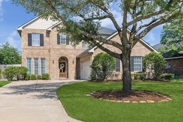 15127 Woodford Hollow Ln, Cypress, TX 77429 - traditional-style home with brick siding, a garage, driveway, and a front yard