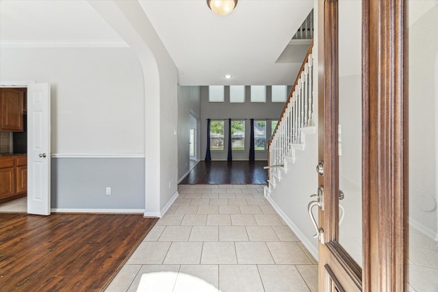 15127 Woodford Hollow Ln, Cypress, TX 77429 - entryway with light wood-type flooring, ornamental molding, stairs, baseboards, and french doors
